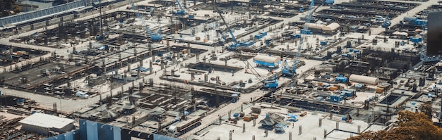 Large construction site with heavy construction machinery in metropolis