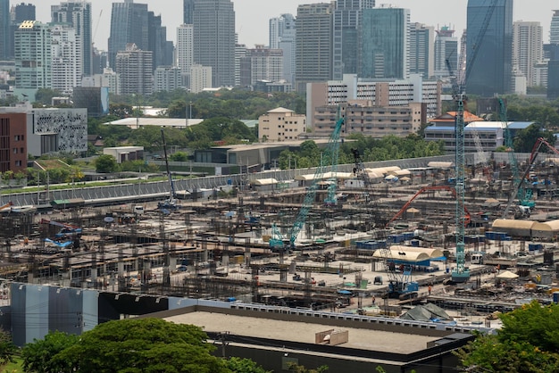 Large construction site with heavy construction machinery in metropolis