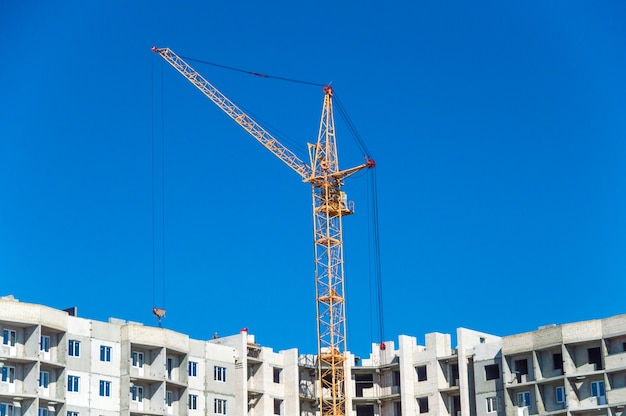 Large crane and multi-storey houses under construction