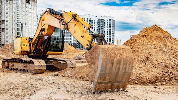 large crawler excavator at the construction site closeup of an excavator bucket with the boom extended rental of construction equipment earthworks in construction