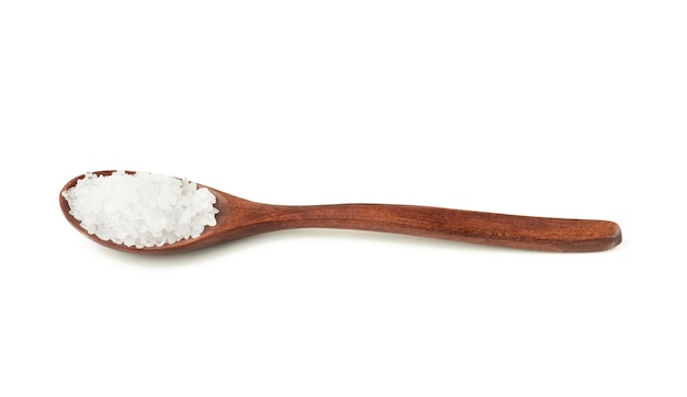 Large crystals of white sea salt in a brown wooden spoon