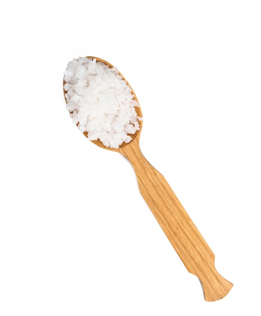 Large crystals of white sea salt in a brown wooden spoon