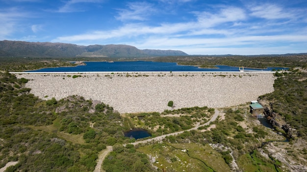 A large dam with a mountain in the background