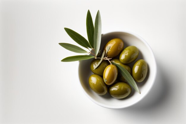 Large delicious green olives with leaves in olive oil isolated on a white backdrop top view