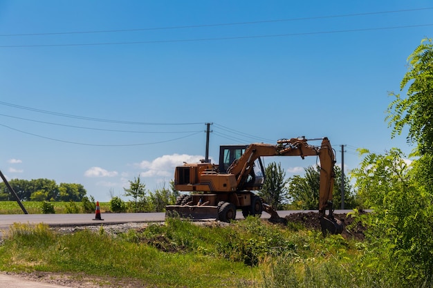 Large excavator digging bucket on construction of high-speed road. Heavy machine equipment for excavation works at civil industrial construction