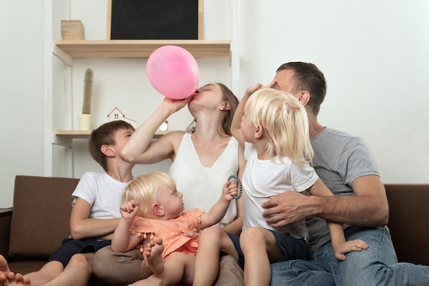 Large family at home preparing for the holiday and inflating balloon