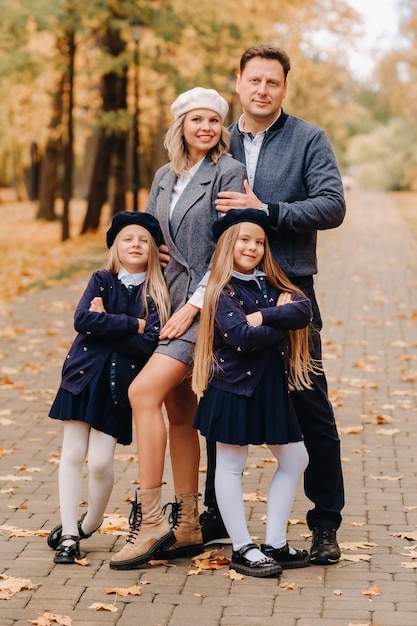 A large family walks in the park in the fall Happy people in the autumn park