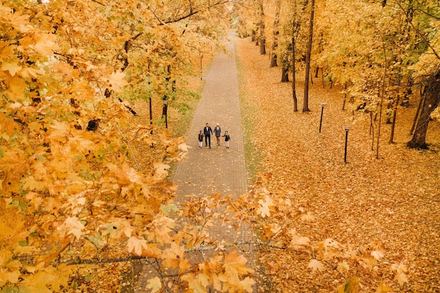 A large family walks in the park in the fall Happy people in the autumn park