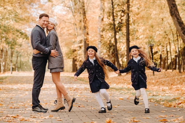 A large family walks in the park in the fall Happy people in the autumn park