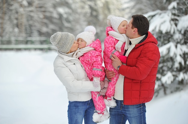 A large family with children on a walk in winter in the forest.