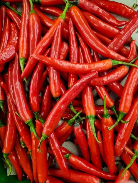 large of fresh red chilies on display in the supermarket or grocerie store