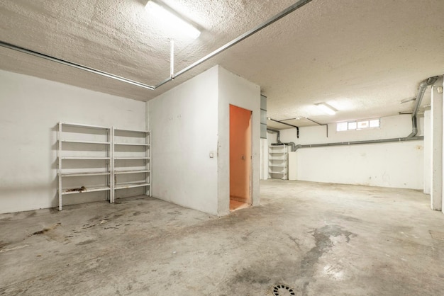 A large garage of a singlefamily home with whitepainted walls