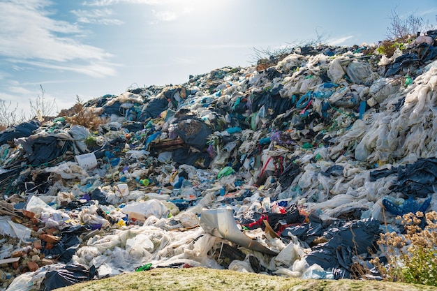 Large garbage pile on sky background. Pile of domestic garbage in landfill