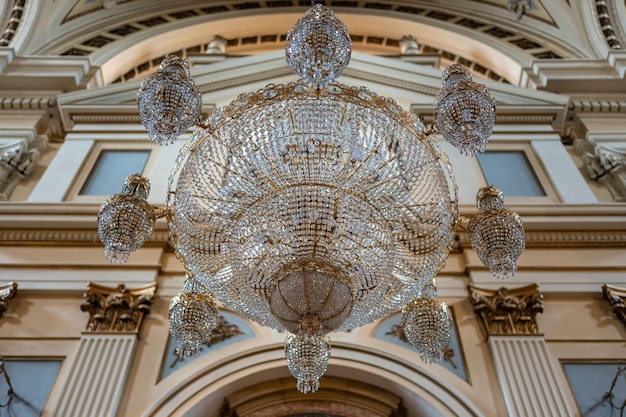 Large glass lamp hanging from the ceiling of the huge cathedral basilica del Pilar Zaragoza