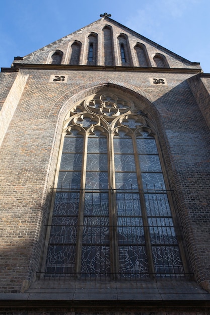 Large gothic window at the facade of old catholic church