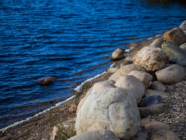 Large granite boulders on the banks of the river closeup