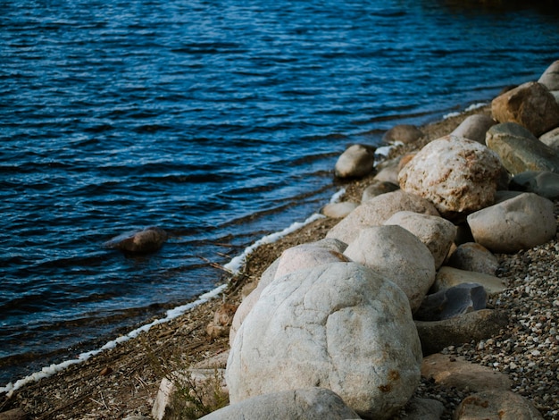 Large granite boulders on the banks of the river closeup