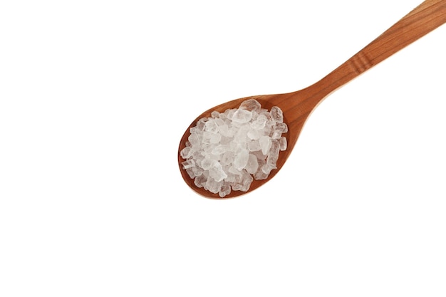 Large granules Citric acid salt or Lemon salt crystals in wooden spoon on white background