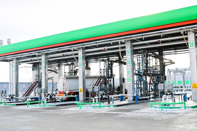 Large green industrial gas station for refueling vehicles trucks and tanks with fuel gasoline