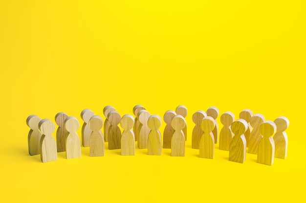 A large group of figurines of people on a yellow background social survey and public opinion