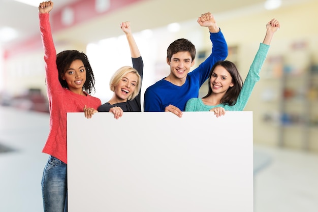 Large group holding a big white board.