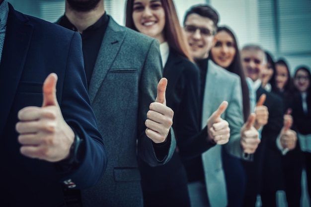 Large group of young entrepreneurs showing thumbs up . the concept of teamwork