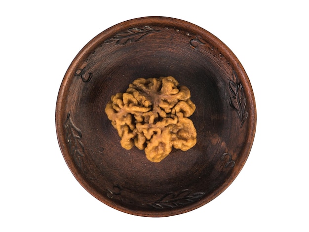 A large gyromitra mushroom in a clay bowl isolated on a white background Spring mushrooms