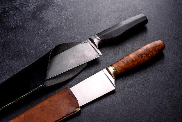 A large handmade hunting knife lying on a dark background