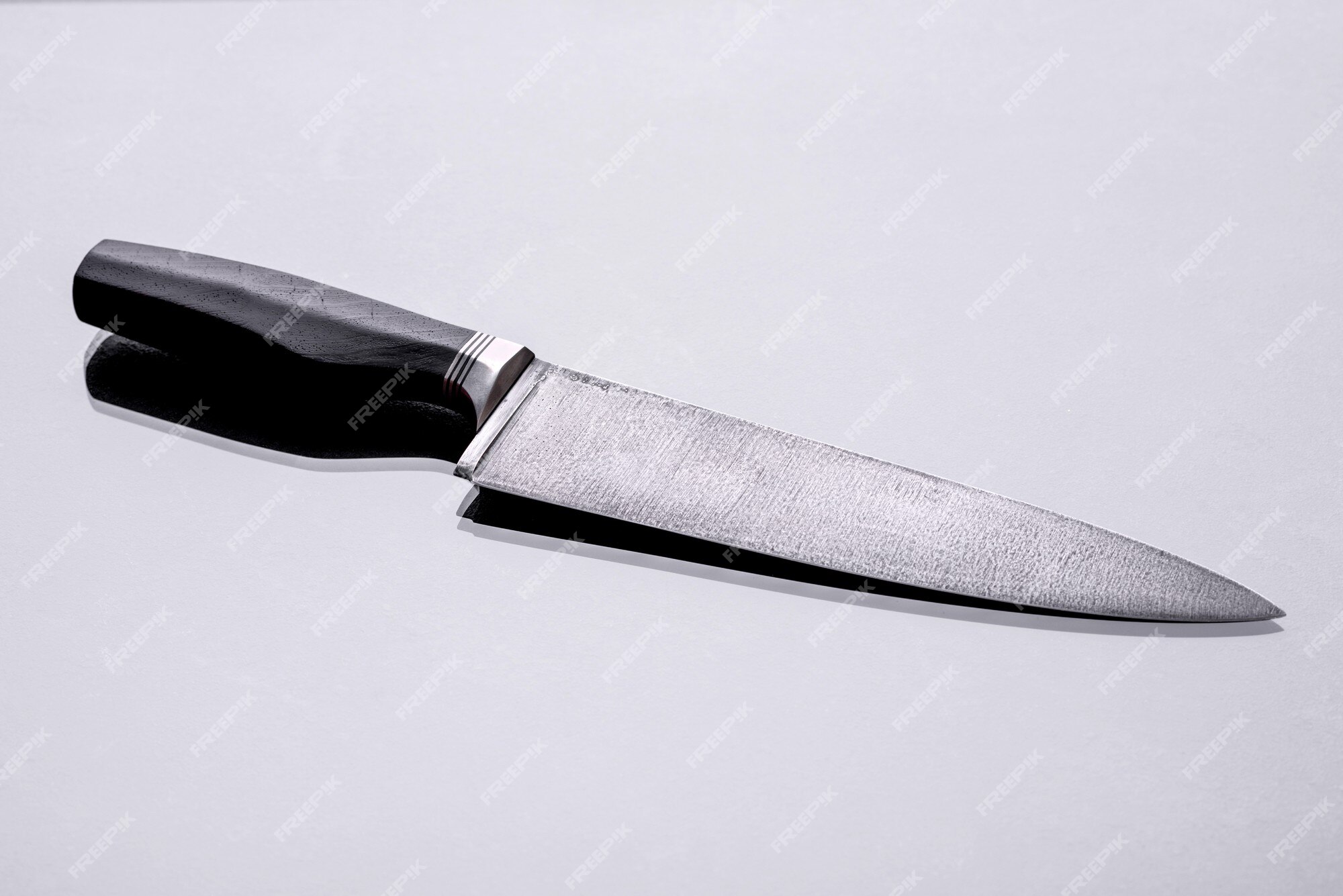 https://img.freepik.com/premium-photo/large-handmade-hunting-knife-lying-dark-monotone-background_73989-18054.jpg?w=2000