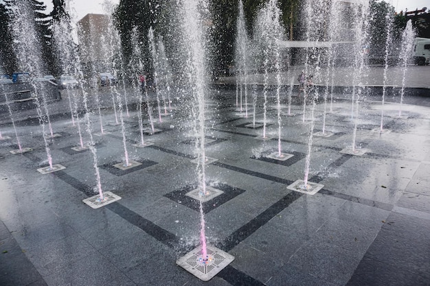 A large illuminated water fountain in the center of the city