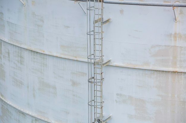 Large Industrial tanks for oil with a walkway up and down of oil storage tank metal stairs