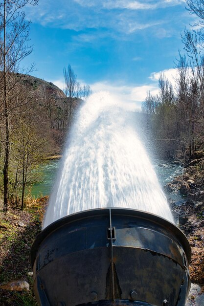 Large jet of water coming out of the outlet of the Beleña reservoir, Guadalajara (Spain).