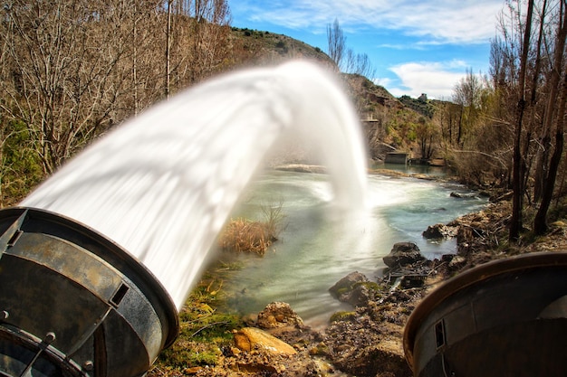 Large jet of water coming out of the outlet of the Beleña reservoir, Guadalajara (Spain).