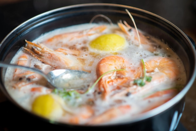 Large king prawns are cooked and boiled in saucepan Cooking with spices and lemon