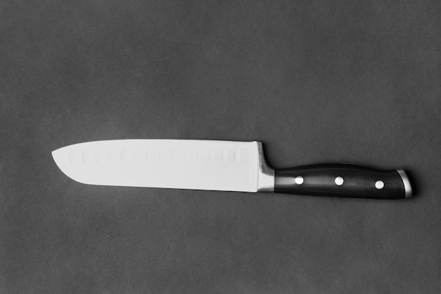 Large kitchen knife on a black background