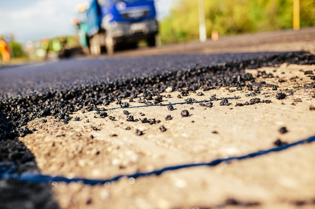 A large layer of fresh hot asphalt Road construction Construction of a new road