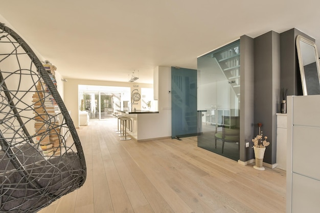 A large living room with a staircase and a kitchen