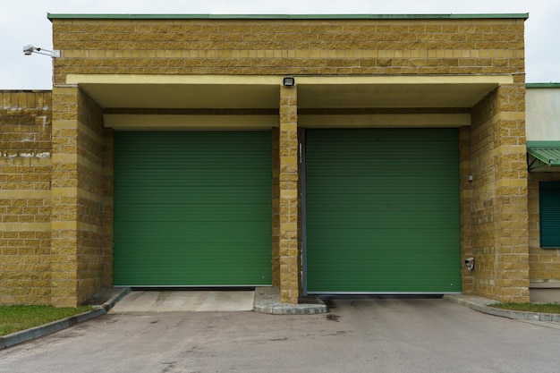 Large metal garage doors Modern automatic garage door Closed roller gates Safe storage of the car