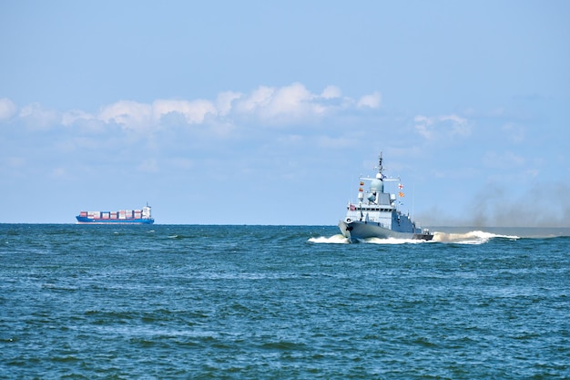 Large missile boat during naval exercises and parade, guided missile destroyer by Russian Navy maneuvering in Baltic Sea. Modern military naval warship sailing in vibrant blue sea