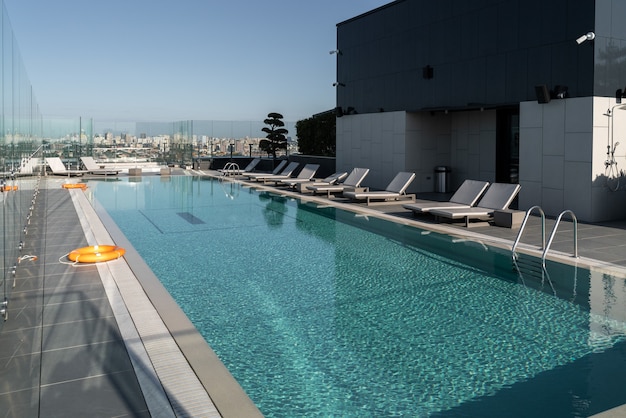 Large, modern pool with sunbeds and lifebuoys. The concept of recreation