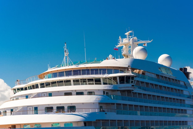 A large multistorey ship against the blue sky