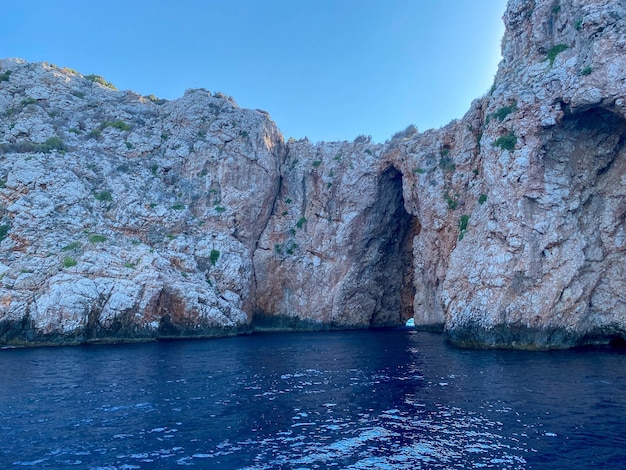 Large natural beautiful cave in the rock and the sea is blue warm in a tourist tropical country