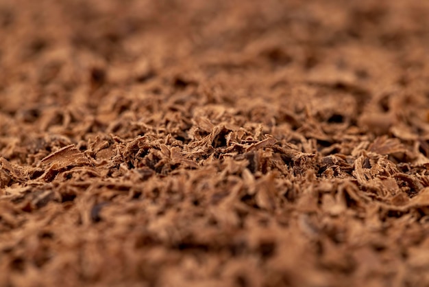 A large number of chocolate chips on the surface crumbs and pieces of chocolate that are used in cooking and dessert preparation