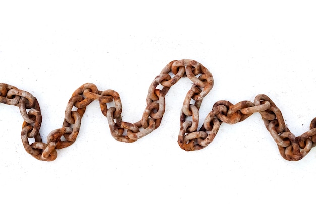 Large old rusty chain on white surface