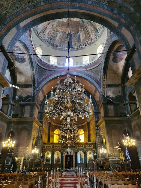 A large ornate chandelier hangs from the ceiling of a church.