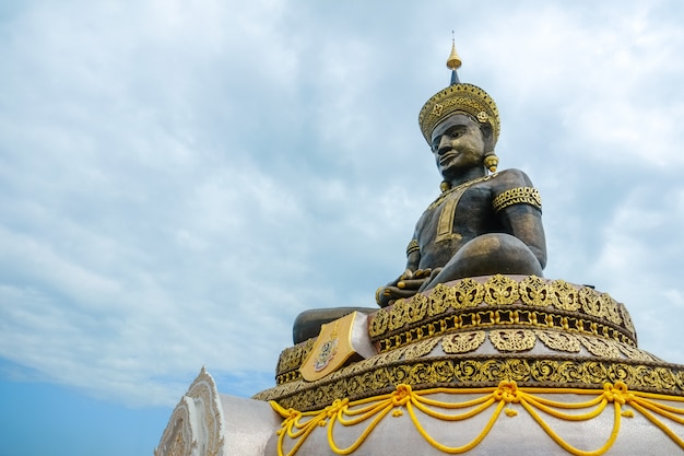 Large outdoor bronze statue of Buddha Maha Thammaracha at Wat Traiphum temple. Phetchabun, Thailand.