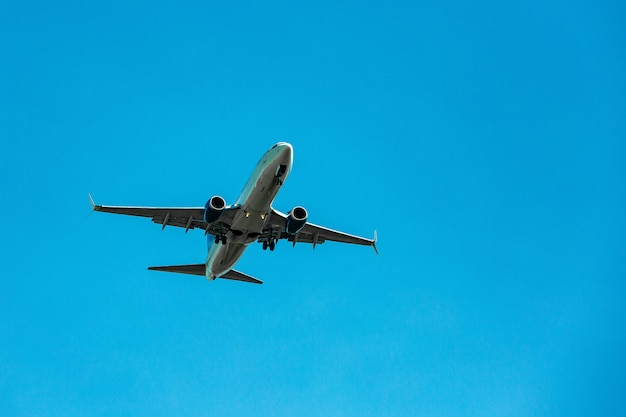 Large passenger plane flying in the blue sky