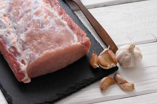 A large piece of pork loin on a rustic white background