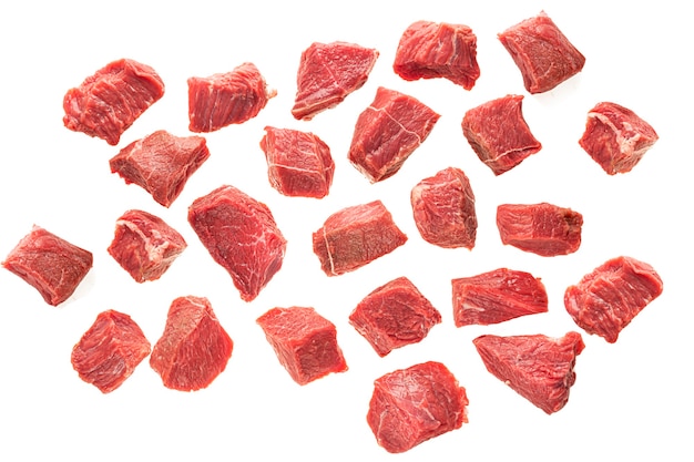 Large pieces of beef meat on a white background of isolate. sliced red meat cubes.