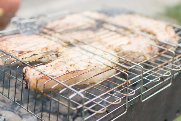 Large pieces of pork ribs on the grill Preparation of meat roasted on coals